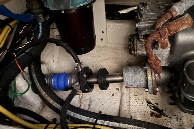 Slide: The Image of Engine compartment of a 2011 Luhrs 30 Open boat, showing mechanical components and wiring. - 24