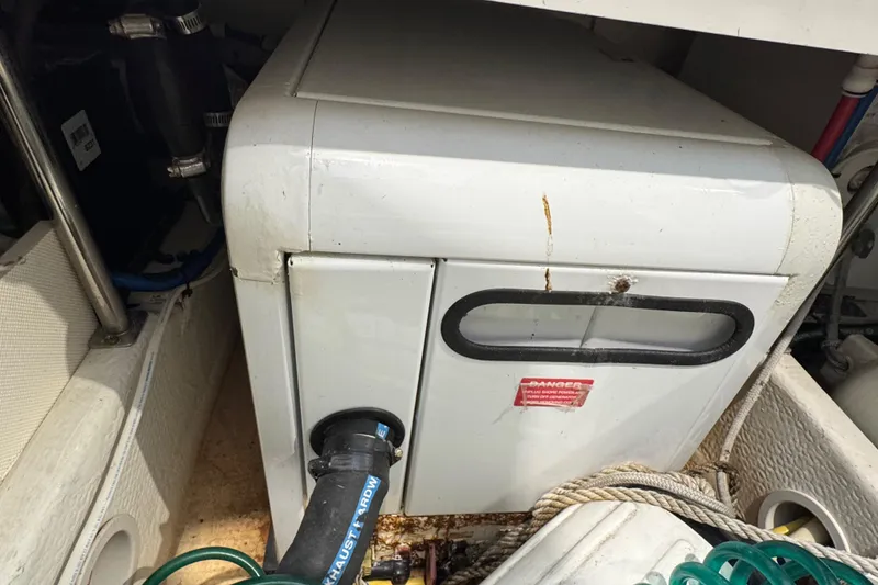 Slide: The Image of Engine compartment of 2011 Luhrs 30 Open boat with visible machinery and hoses. - 25