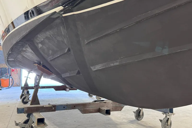 Slide: The Image of 2011 Luhrs 30 Open boat hull on a wheeled stand in a workshop. - 27