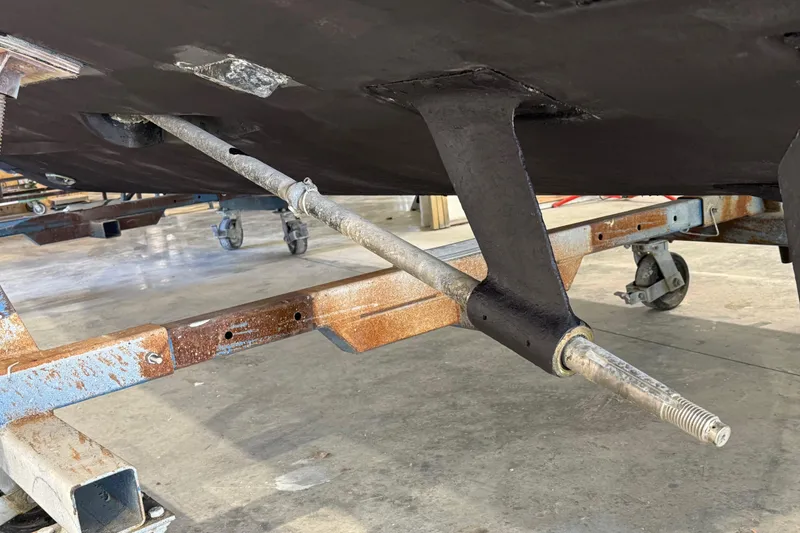 Slide: The Image of Underside view of 2011 Luhrs 30 Open boat on a trailer in a workshop. - 29