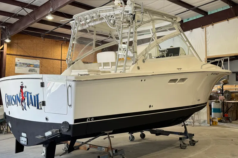 Slide: The Image of 2011 Luhrs 30 Open boat in a workshop, featuring sleek design and sturdy build. - 3