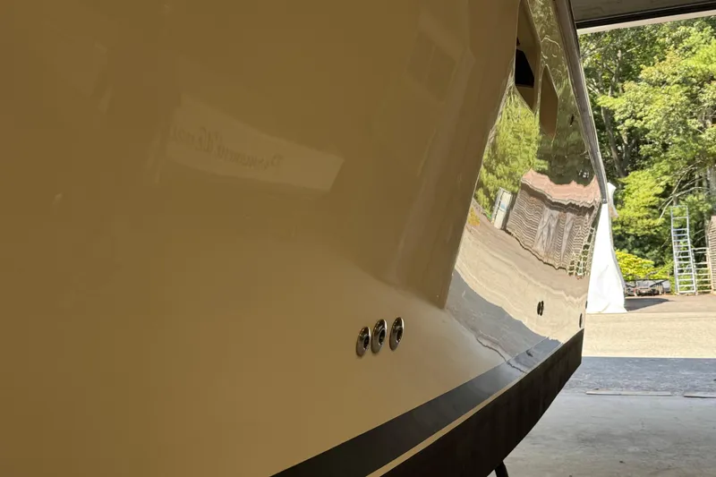 Slide: The Image of 2011 Luhrs 30 Open boat hull reflecting outdoor scenery. - 8