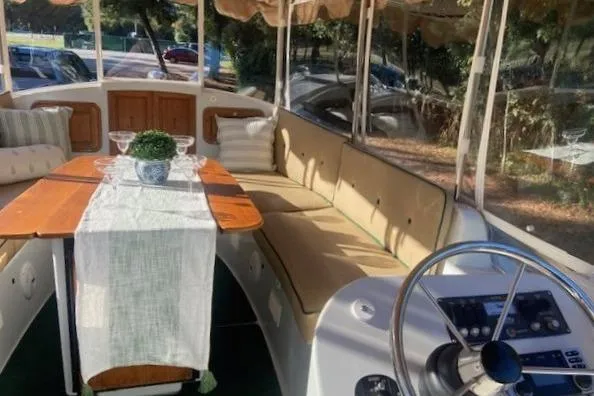 Slide: The Image of 2007 Duffy 22' Cuddy Cabin boat interior with seating, table, and steering wheel. - 10