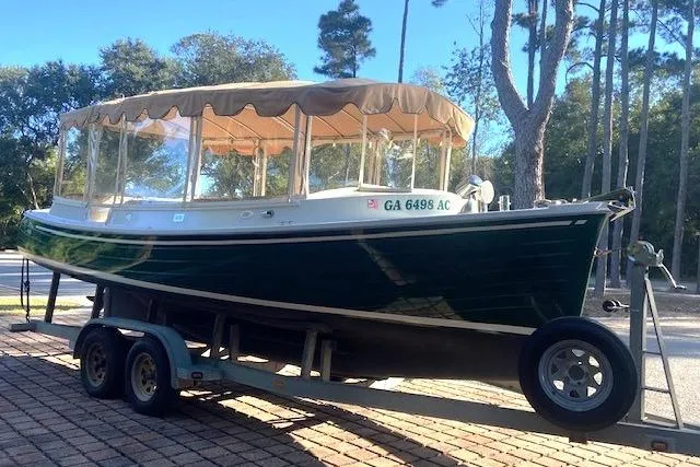 Slide: The Image of 2007 Duffy 22' Cuddy Cabin boat on trailer, green hull, parked outdoors. - 12