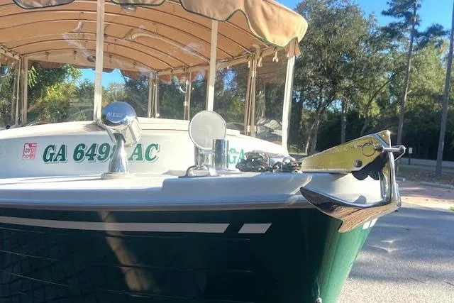 Slide: The Image of 2007 Duffy 22' Cuddy Cabin boat with canopy, docked outdoors, registration GA 649 AC visible. - 2