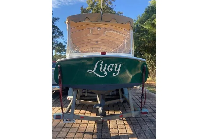 Slide: The Image of 2007 Duffy 22' Cuddy Cabin boat named "Lucy" on a trailer, green hull. - 4
