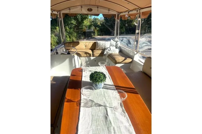 Slide: The Image of Interior of a 2007 Duffy 22' Cuddy Cabin boat with elegant seating and table setup. - 6