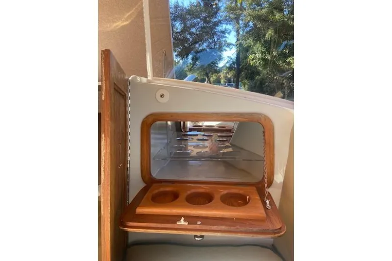 Slide: The Image of 2007 Duffy 22' Cuddy Cabin interior with wooden cup holders and window view. - 9