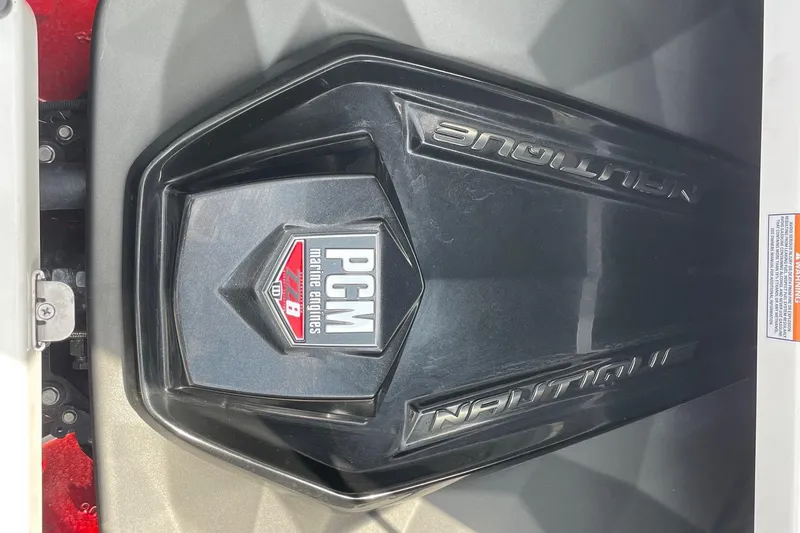 Slide: The Image of 2023 Nautique Super Air Nautique G23 engine cover with PCM marine engines logo. - 13