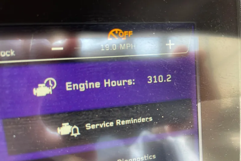 Slide: The Image of Display screen of 2023 Nautique Super Air Nautique G23 showing 310.2 engine hours. - 14