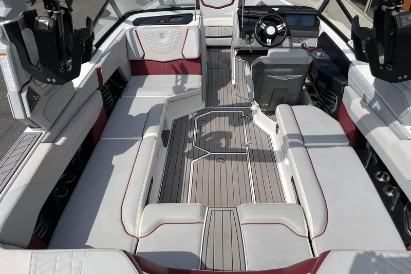 Slide: The Image of 2023 Nautique Super Air Nautique G23 interior with luxurious seating and modern dashboard. - 5
