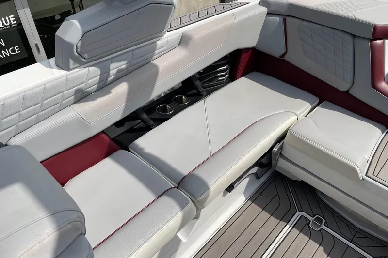Slide: The Image of 2023 Nautique Super Air Nautique G23 interior with luxurious seating and cup holders. - 7