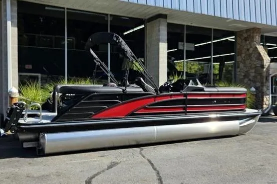 The Image of 2026 Bennington 23 RFB pontoon boat with sleek black and red design, parked outdoors. - 0