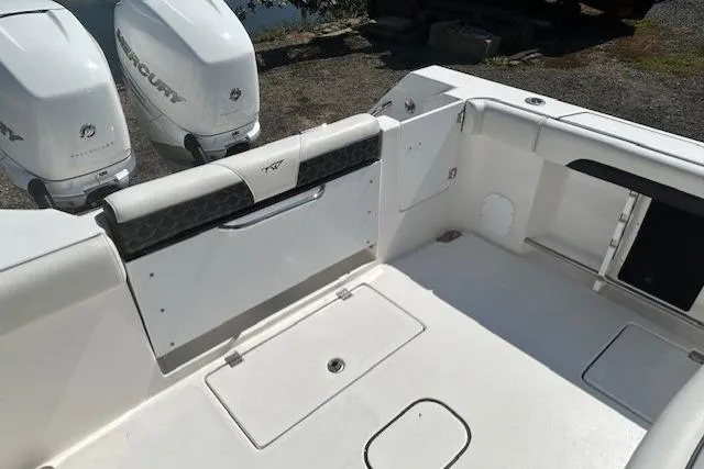 Slide: The Image of 2021 Tidewater 320 CC Adventure boat docked in a scenic marina. - 16