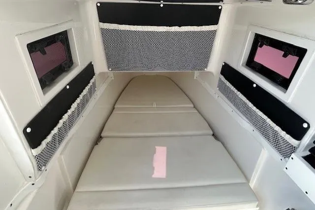 Slide: The Image of 2021 Tidewater 320 CC Adventure boat interior with rod holders and seating. - 19