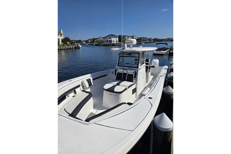 Slide: The Image of 2021 Tidewater 320 CC Adventure boat interior with helm seating and steering wheel. - 30