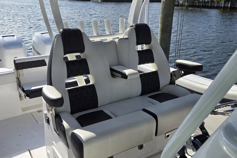 Slide: The Image of 2021 Tidewater 320 CC Adventure boat cockpit with modern controls and steering wheel. - 32