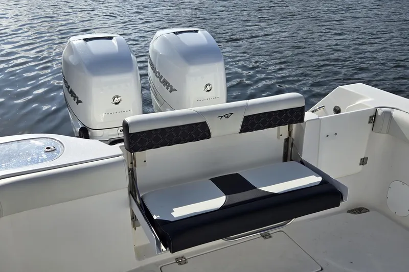 Slide: The Image of 2021 Tidewater 320 CC Adventure boat interior with white and black seating. - 33