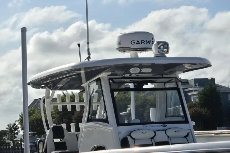 Slide: The Image of 2021 Tidewater 320 CC Adventure boat cockpit with modern controls and steering wheel. - 34
