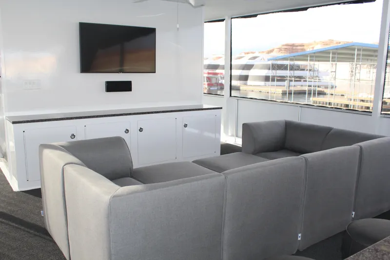 Slide: The Image of Modern lounge area in Adonia Harmony Share #4, 2020, with gray sofas and wall-mounted TV. - 13