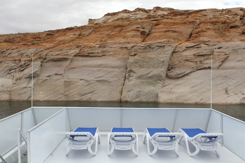Slide: The Image of Four deck chairs on Adonia Harmony Share #4, 2020, facing scenic rocky landscape. - 16