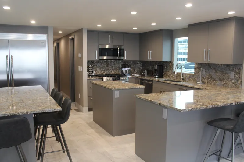 Slide: The Image of Modern kitchen with granite countertops, stainless steel appliances, and sleek gray cabinetry, Adonia Harmony Share #4. - 17