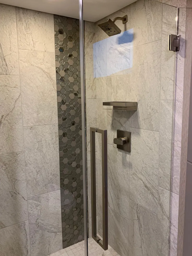 Slide: The Image of Modern shower with glass door, hexagonal tile accent, and sleek fixtures in Adonia Harmony Share #4. - 8