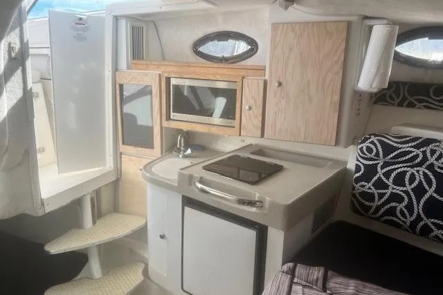 Slide: The Image of Interior of 2000 Wellcraft 2900 Coastal WA boat with kitchenette and seating area. - 12