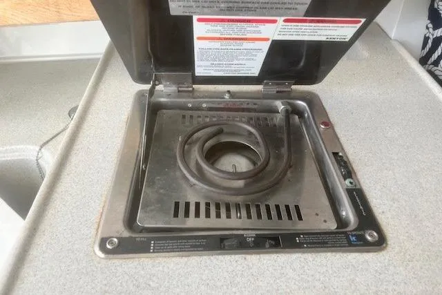 Slide: The Image of Stove on 2000 Wellcraft 2900 Coastal WA boat, featuring a single burner and control panel. - 14