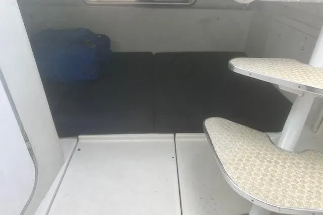 Slide: The Image of 2000 Wellcraft 2900 Coastal WA cabin interior with seating and steps. - 16
