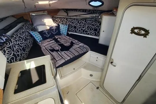 Slide: The Image of 2001 Wellcraft 2900 Coastal WA cabin interior with bed, kitchenette, and storage. - 17
