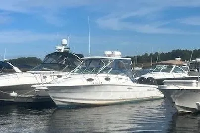 Slide: The Image of 2000 Wellcraft 2900 Coastal WA boat docked among other vessels on a sunny day. - 2