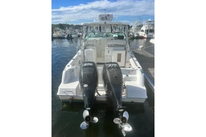 Slide: The Image of 2000 Wellcraft 2900 Coastal WA boat with twin outboard motors docked at marina. - 20