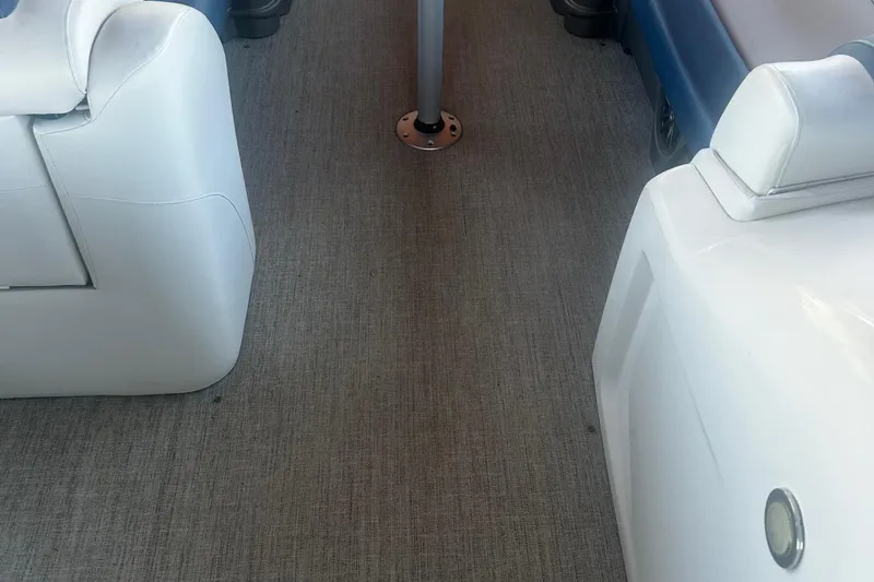 Slide: The Image of Interior of 2020 Avalon Catalina 2585 boat with white seating and carpeted floor. - 12