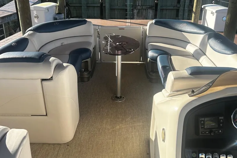 Slide: The Image of 2020 Avalon Catalina 2585 boat interior with plush seating and central table. - 15