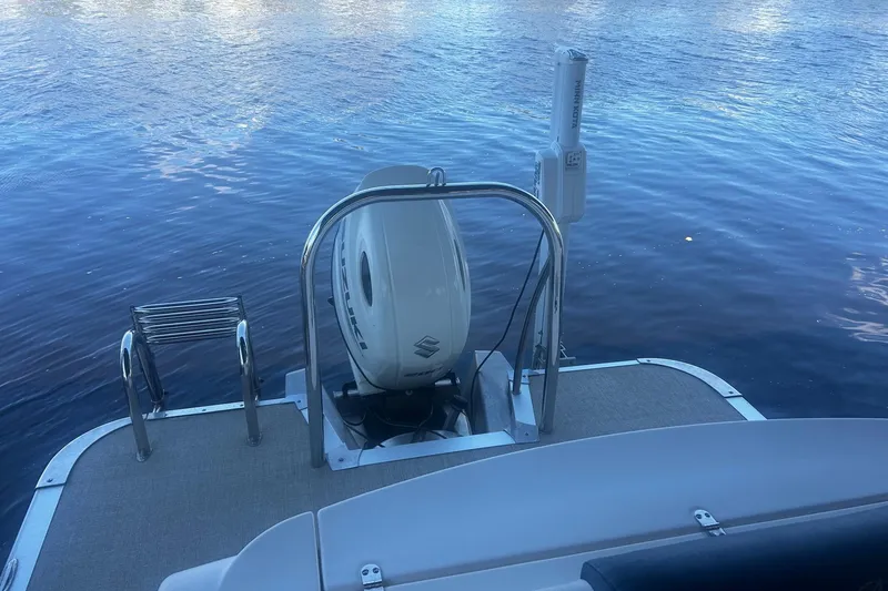 Slide: The Image of 2020 Avalon Catalina 2585 pontoon boat docked by the water. - 5