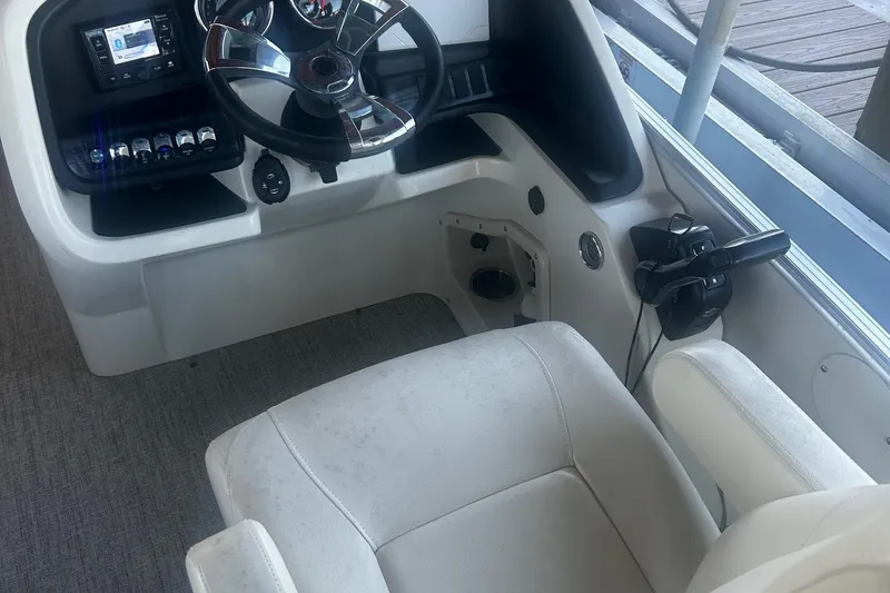 Slide: The Image of 2020 Avalon Catalina 2585 pontoon boat docked, featuring blue and white seating. - 7