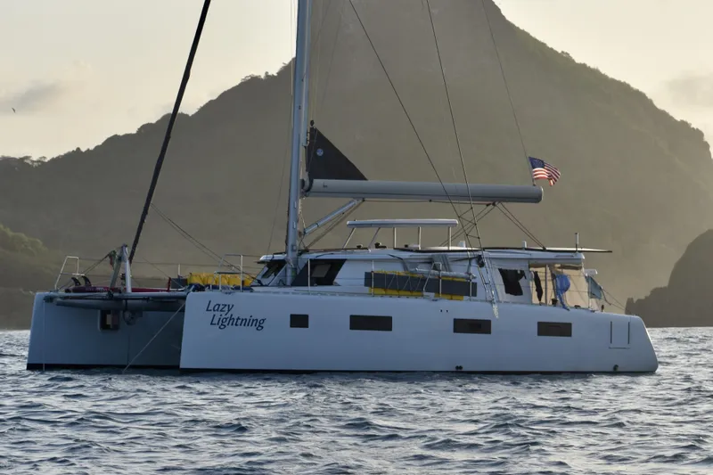 Slide: The Image of Catamaran "Lazy Lightning" sailing near mountainous coastline, Vision 444 model, 2021. - 1