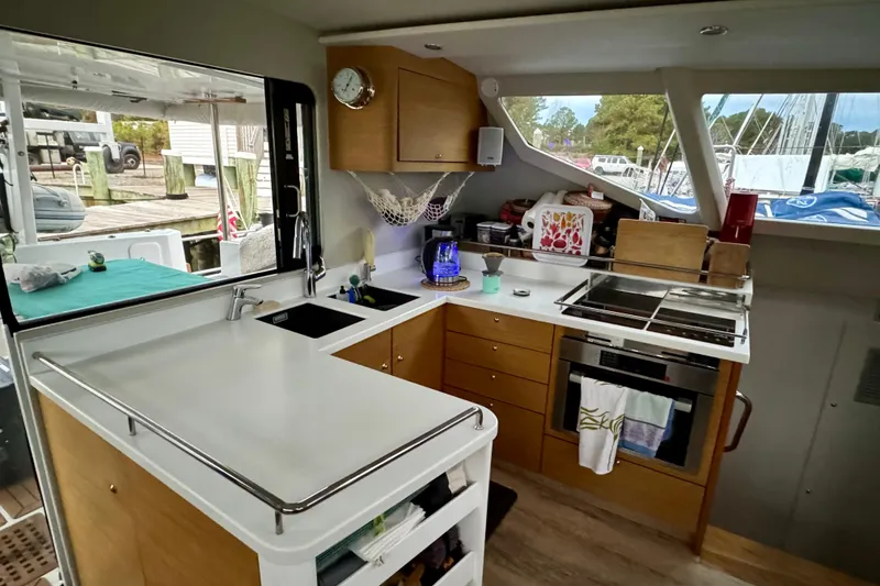 Slide: The Image of Modern yacht kitchen interior with wooden cabinets, stove, and large windows. Vision 444, 2021 model. - 11