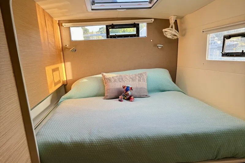 Slide: The Image of Cozy bedroom in Vision 444, 2021 model, with plush bedding and decorative pillow. - 13