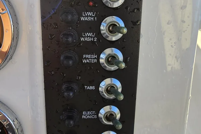 Slide: The Image of Control panel of a 2017 Robalo R222 Center Console boat with switches for various functions. - 22