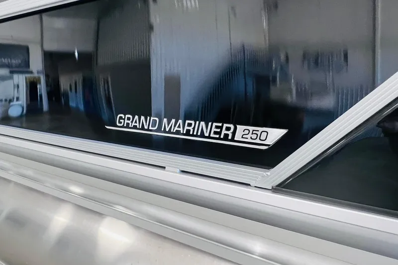 Slide: The Image of 2025 Harris 250 Grand Mariner V10 400 boat logo in showroom setting. - 4
