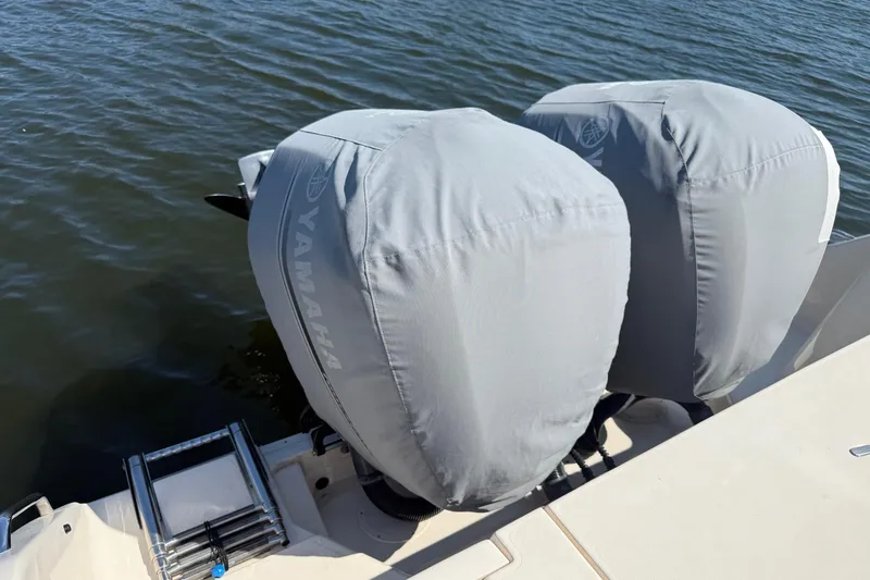 Slide: The Image of 2017 Grady-White Canyon 271 FS with covered Yamaha outboard motors on water. - 12