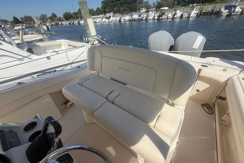 Slide: The Image of 2017 Grady-White Canyon 271 FS boat interior with seating, docked at marina. - 23