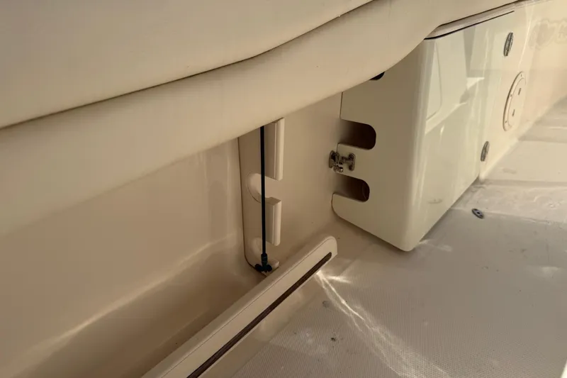 Slide: The Image of 2017 Grady-White Canyon 271 FS boat interior detail, showcasing storage compartment and seating. - 26