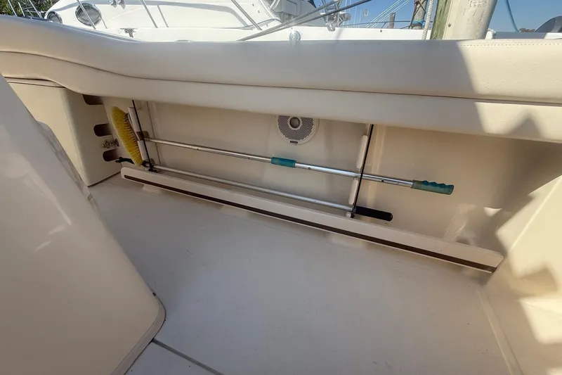 Slide: The Image of 2017 Grady-White Canyon 271 FS boat interior storage with cleaning tools. - 28