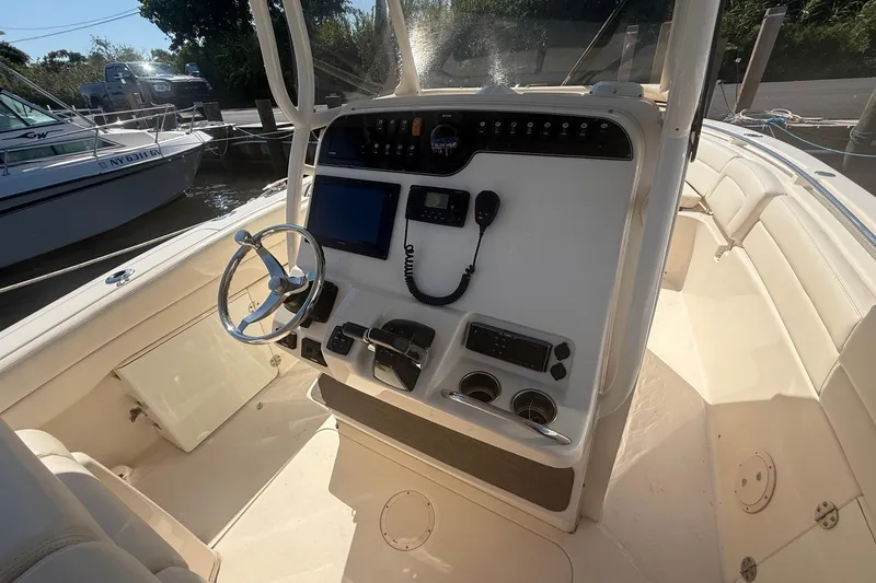 Slide: The Image of 2017 Grady-White Canyon 271 FS boat console with steering wheel and navigation equipment. - 33