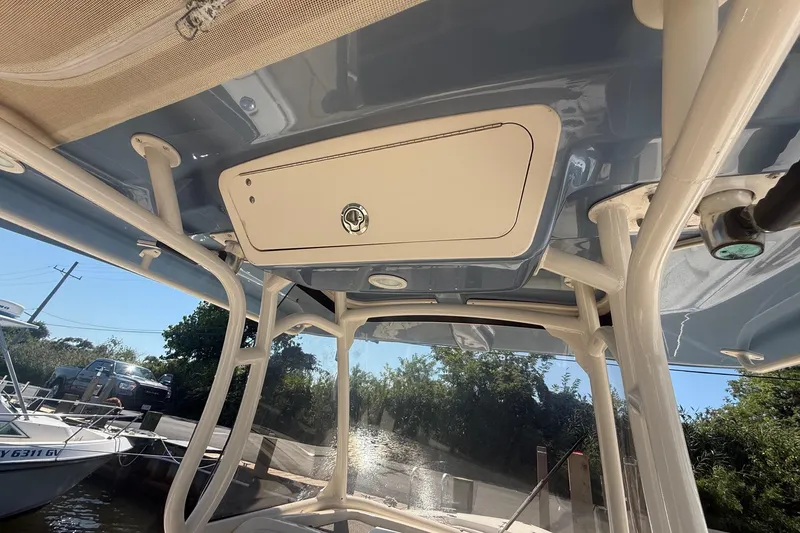 Slide: The Image of 2017 Grady-White Canyon 271 FS boat interior with storage compartment and canopy. - 34