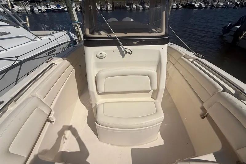 Slide: The Image of 2017 Grady-White Canyon 271 FS boat interior with seating, docked at marina. - 36