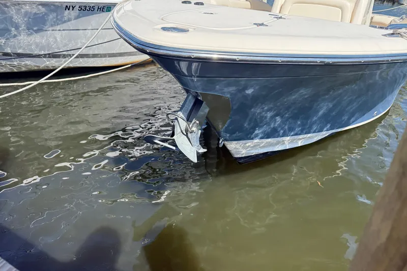 Slide: The Image of 2017 Grady-White Canyon 271 FS boat docked in water, front view. - 5